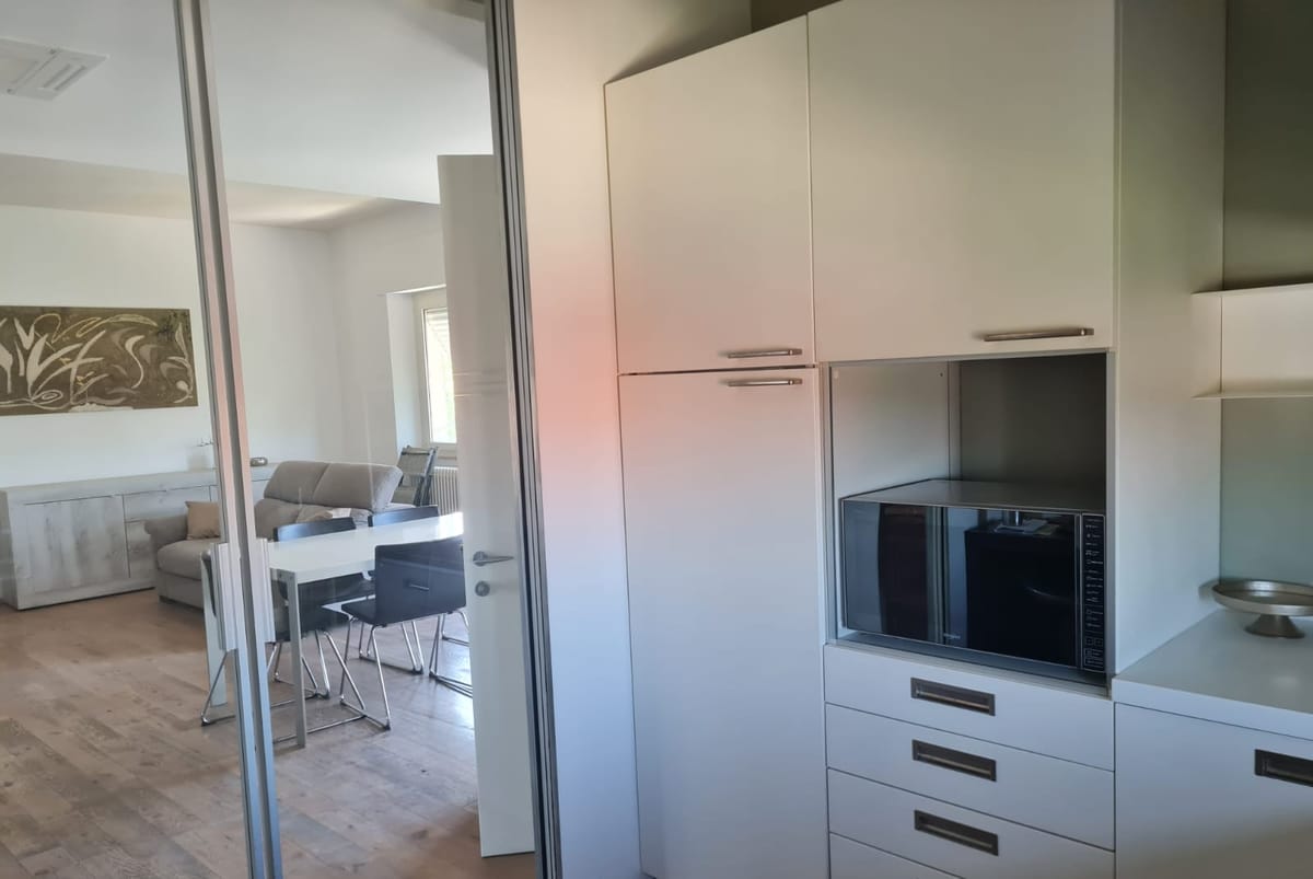 Kitchen of the Sun Apartment looking onto the living area