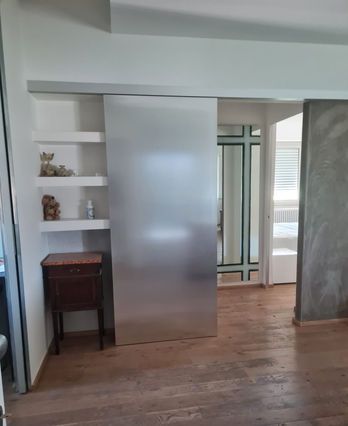 Entrance of the Sun Apartment with sliding door and wooden floor