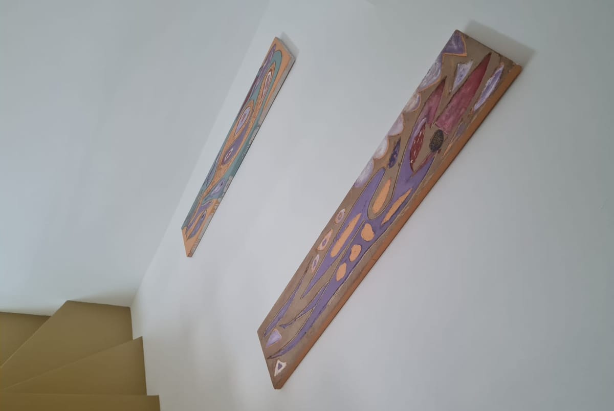 Interior staircase of the Sun Apartment with artwork on the walls